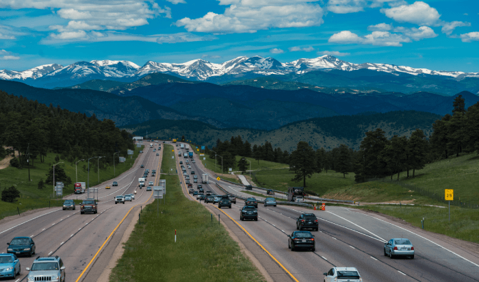A busy highway with cars zooming past each other, creating a blur of motion and a sense of urgency.