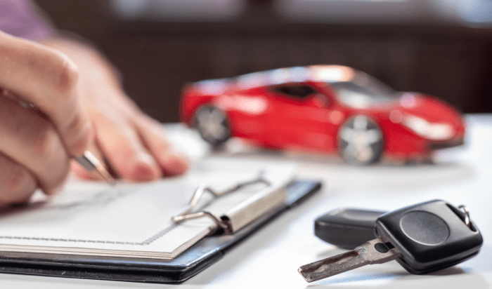 A person fill-up a form for car insurance