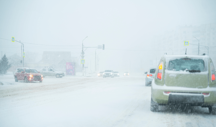 Bunch of cars in the road that full of snow