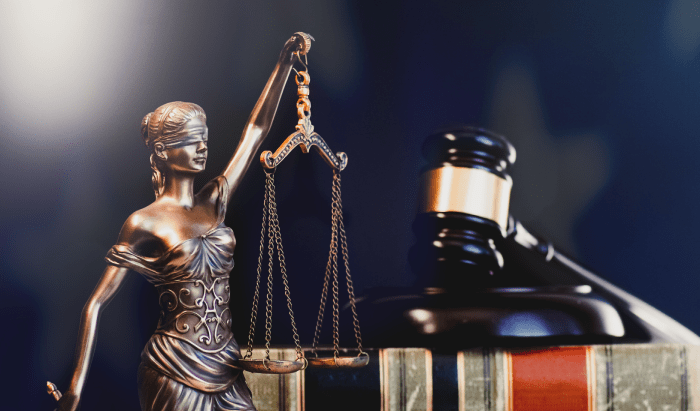 Law and justice symbolized by a lady justice statue and a gavel