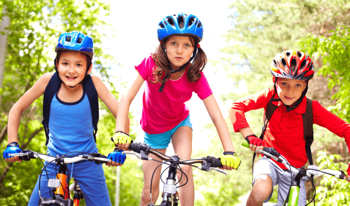 A group of kids riding a bicycle